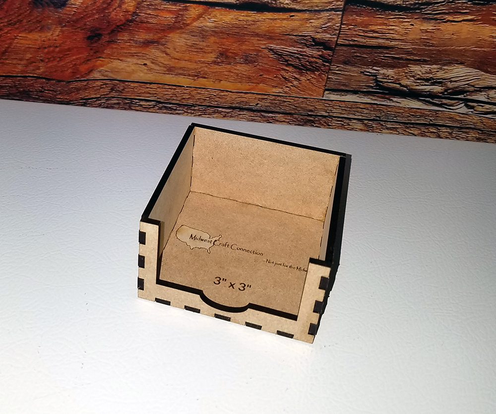 An Original Design By Custom Laser Art Designs.  Laser engraved promotional marketing for Businesses.  Put your logo on everyday items that people will use.  This Midwest Craft Connection logo was put on to this 3 x 3 note cube holder for 3-inch memo note cube paper refills.