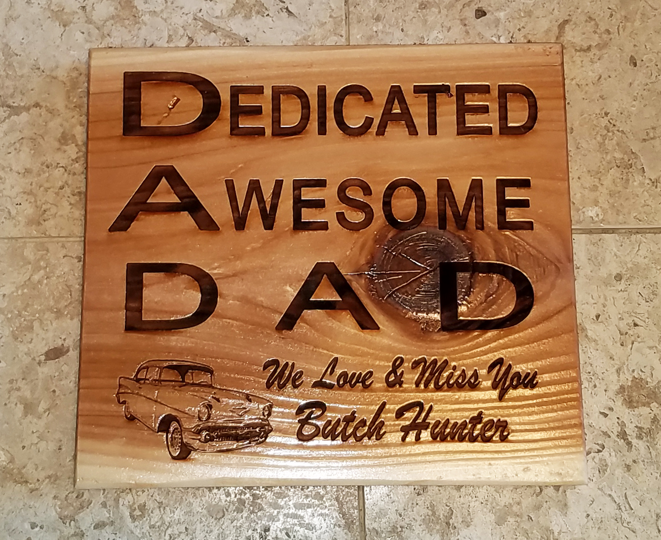 Personalized Design By Custom Laser Art Designs.  It is a laser engraved wooden memorial plaque.  The saying is:  Dedicated Awesome DAD, We Love & Miss You